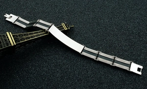 Macro view of men's titanium steel and black silicone bracelet with a blank engravable plate