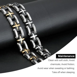 Men's titanium steel bracelet with gold cross links and black silicone on leather background