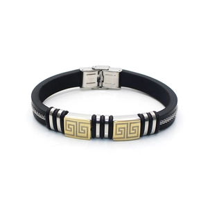 Detail of men's silicone bracelet showing gold Greek meander patterns on metal plates