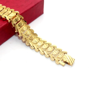 18K gold plated men's chain bracelet with textured scale links on a red jewelry box