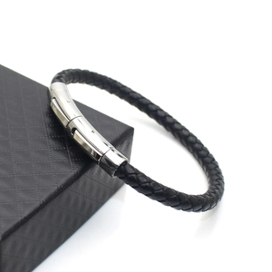 Fashionable black braided leather bracelet for men with silver metal clasp on a gift box