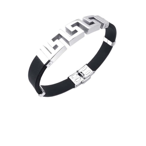 Detail of silver metal plate with Greek key pattern on black silicone bracelet