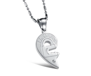 Detail of heart puzzle necklace with I LOVE engraving and small zircon stone inlay