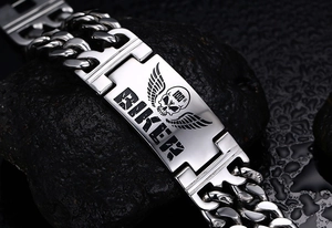 Titanium steel biker skull bracelet with Cuban link chain for men on stone surface