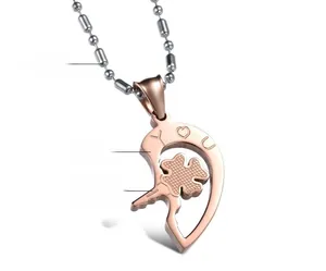 Detail of puzzle heart pendant with rose gold plating and clover engraving for couples