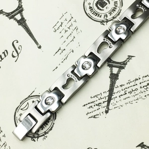 Titanium steel bracelet with crystal-inlaid blocks and hollow footprint charms