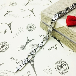 Magnetic titanium steel bracelet featuring footprint patterns and rhinestone flower links