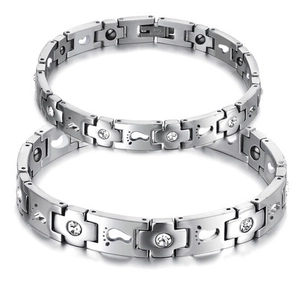 Polished stainless steel magnetic health bracelet with crystal rhinestones and footprint cutouts