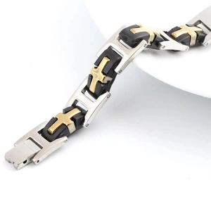 Detail of men's silicone steel bracelet with golden cross charms and folding clasp