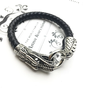 Bracelet pour homme en cuir noir tressé avec un fermoir tête de dragon en argent détaillé