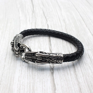 Men's black braided leather bracelet featuring a vintage silver dragon head metal clasp