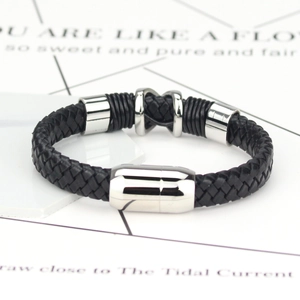 Close-up of woven black leather men's bracelet with polished silver magnetic clasp
