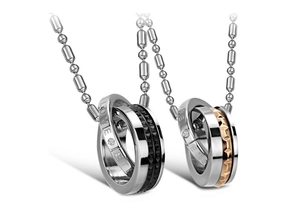 Detail of couple necklaces with interlocking rings, engraved Love text and polished finish