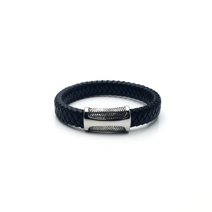 Close-up of black braided leather bracelet for men with textured silver metal magnetic clasp