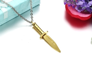 Detailed view of a matte gold dagger pendant necklace on a silver chain with gift box