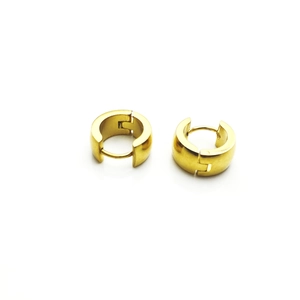 Detailed close-up of chunky gold-plated titanium steel huggie hoop earrings with hinge closure