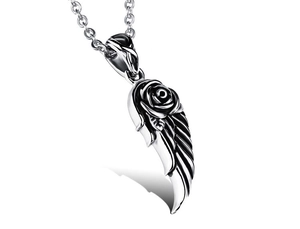 Macro shot of retro stainless steel wing and rose pendant with detailed vintage finish