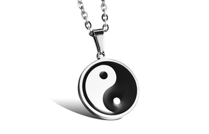 Close-up of a stainless steel Tai Chi Yin Yang pendant on a silver link chain