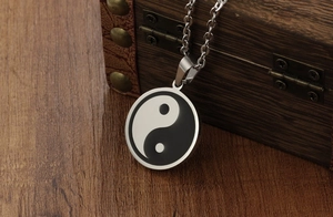 Close-up of vintage Tai Chi Yin Yang pendant on a silver stainless steel chain