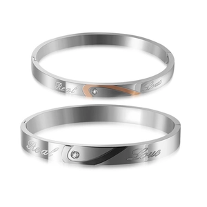 Close-up of titanium steel bracelets with Real Love engraving and CZ stone heart detail