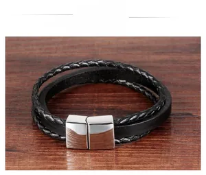 Detail of black double-layered braided leather bracelet with square silver magnetic clasp