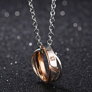 Interlocked stainless steel ring necklace with rose gold finish and a small gemstone