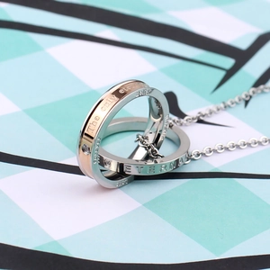 Close-up of interlocking double ring pendant with eternal belief engraving and crystals