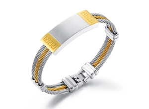 Detailed macro view of steel wire cable bracelet with golden Greek fret pattern