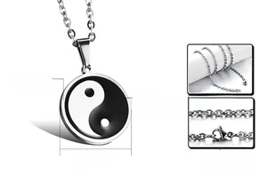 Macro detail of Tai Chi Yin Yang pendant showing 27mm diameter and stainless steel texture