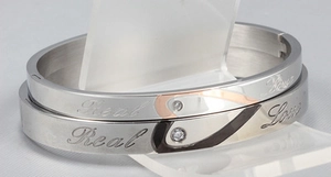 Polished stainless steel couple bracelets with Real Love engraving and tiny crystal studs