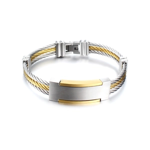 Polished titanium steel cable bracelet with gold accents and rectangular plate