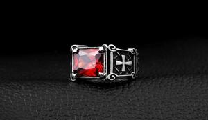 Macro detail of men's vintage ring featuring a red square ruby and engraved side cross