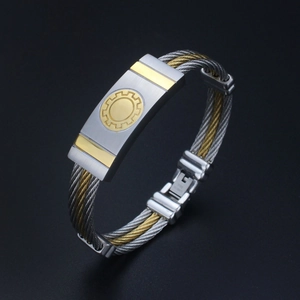 Men's two-tone stainless steel cable bracelet with golden gear emblem and fold-over clasp