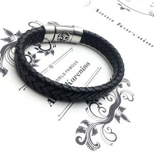 Minimalist men's black braided leather bracelet with silver metal clasp and round totem