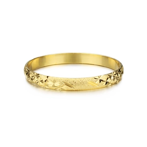 Detailed macro view of 18K gold plated bangle featuring frosted texture and starburst engravings