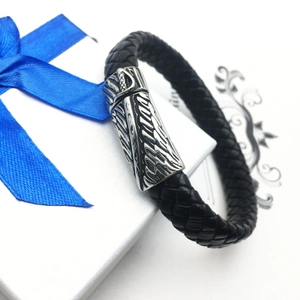 Braided black leather men's bracelet with silver wing engraving on a white gift box