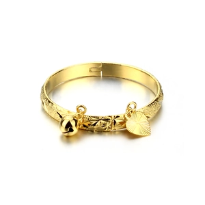 Close-up of 18K gold-plated kids' bangle featuring matte finish, bell and fan charms