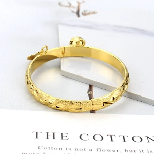 Elegant 18K gold-plated bangle featuring star engravings with bell and heart charms