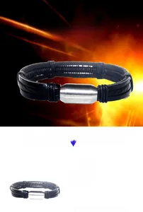 Detail of multi-layer black braided leather bracelet with magnetic steel clasp