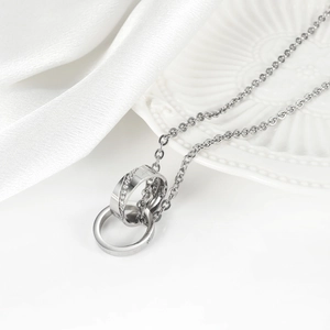 Macro shot of silver interlocking rings necklace with sparkling crystals and fine engraving