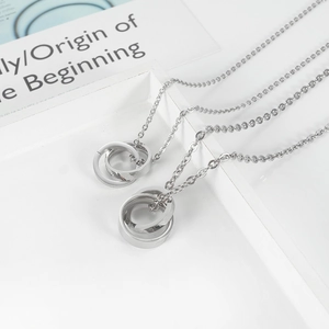 Macro detail of polished interlocking rings with engraved love text on metal O-chain