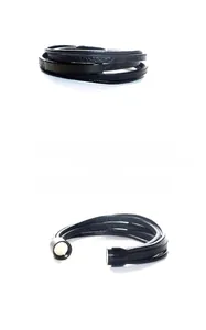 Detailed macro view of black multi-layer braided leather bracelet with magnetic metal clasp