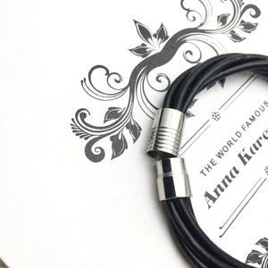 Detail of multi-strand braided leather bracelet with silver magnetic textured clasp