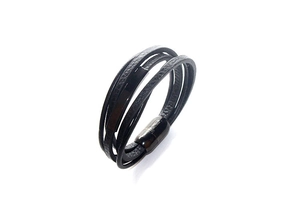 Close-up of black multilayer braided leather bracelet with magnetic metal clasp detail