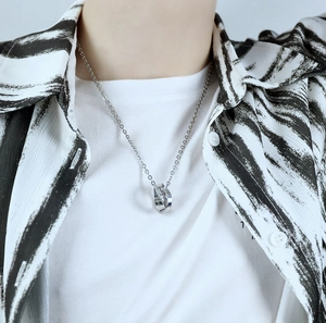 Detail of silver double interlocking rings necklace with cubic zirconia on model