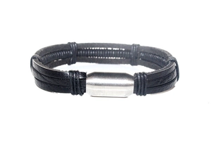 Detail of multilayer men leather bracelet with black coils and silver magnetic clasp