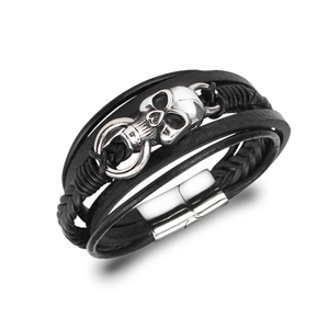 Dettaglio del bracciale in pelle multistrato con teschio in metallo e chiusura magnetica
