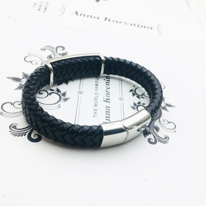 Men's braided black leather bracelet with polished silver skull-themed stainless steel clasp