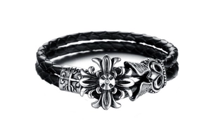 Detail of black braided leather men's bracelet with vintage silver cross metal buckle