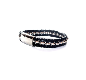 Close-up of black braided leather men's bracelet with silver beads and magnetic clasp